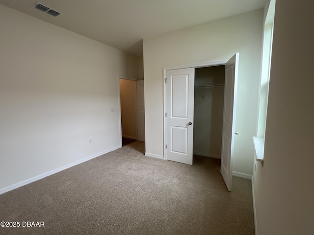 unfurnished bedroom with carpet and a closet