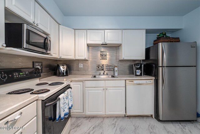 2800 N Atlantic Ave Unit 1105, Daytona Beach, FL 32118 - kitchen with appliances with stainless steel finishes, light countertops, and white cabinets