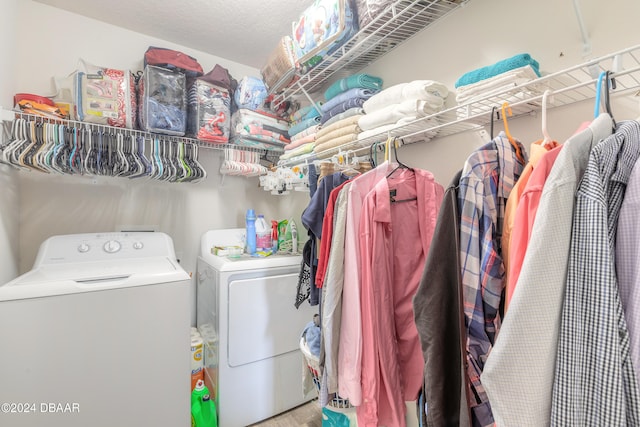 laundry room with separate washer and dryer and a textured ceiling