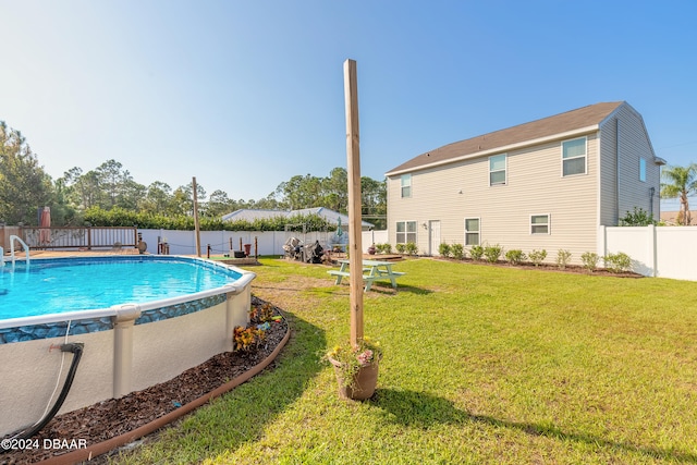 view of pool featuring a yard