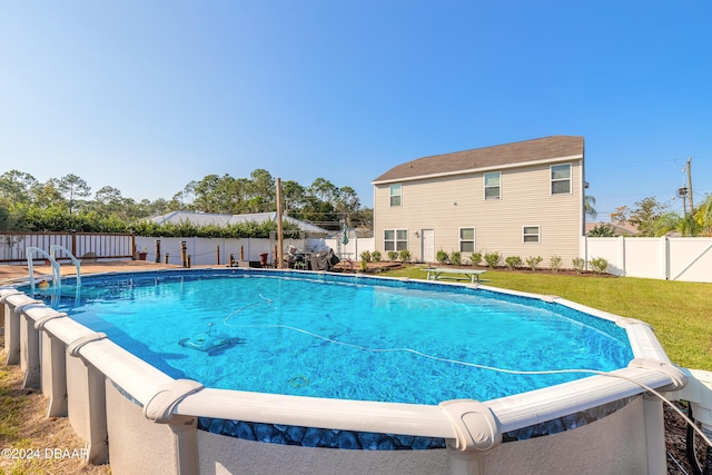 view of pool featuring a lawn