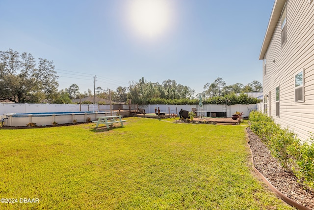 view of yard with a fenced in pool