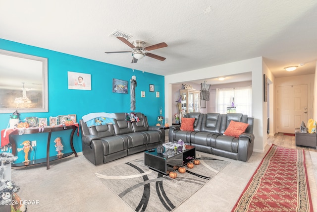 living room with carpet, a textured ceiling, and ceiling fan