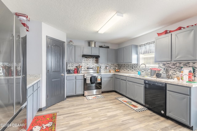 kitchen with dishwasher, sink, gray cabinetry, ventilation hood, and stainless steel electric stove