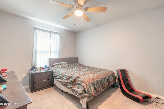 bedroom with light carpet and ceiling fan