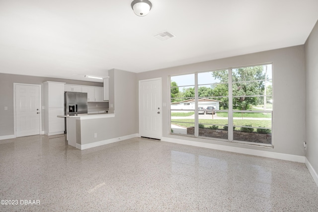 unfurnished living room with a wealth of natural light