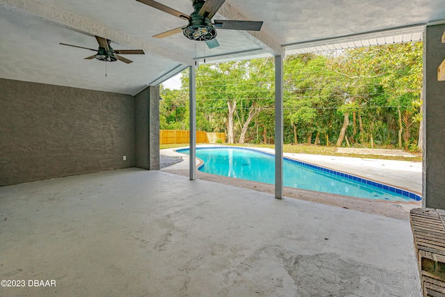 view of swimming pool with ceiling fan and a patio