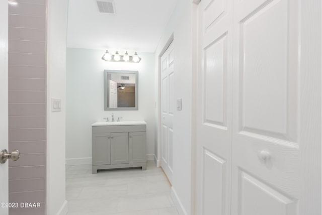 284 Military Blvd, Ormond Beach, FL 32174 - bathroom featuring baseboards, vanity, and marble look tile flooring