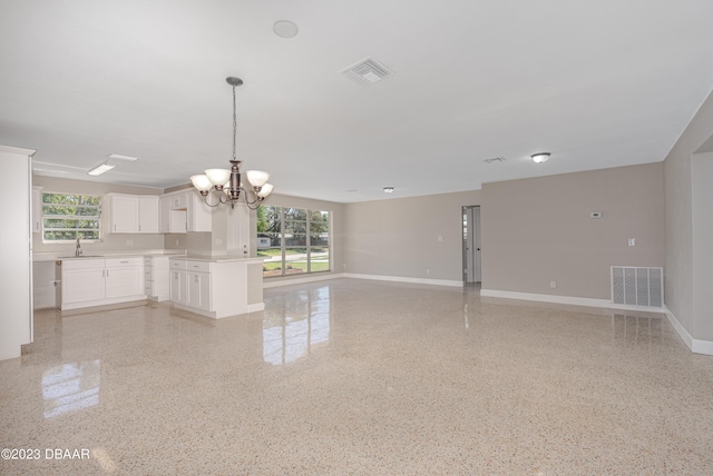 interior space featuring sink, an inviting chandelier, and a healthy amount of sunlight