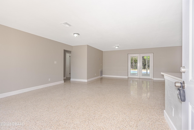 284 Military Blvd, Ormond Beach, FL 32174 - spare room featuring speckled floor, baseboards, and french doors
