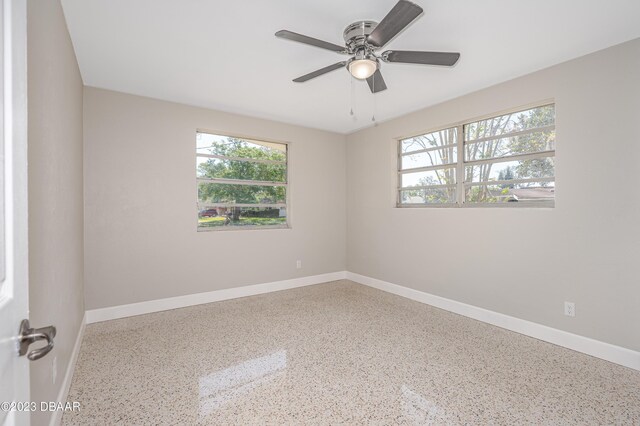 284 Military Blvd, Ormond Beach, FL 32174 - empty room featuring speckle patterned floor, baseboards, and a ceiling fan
