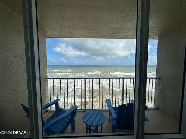 balcony with a beach view and a water view