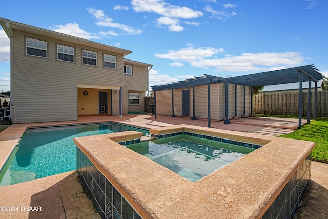 view of pool with a patio area, a pergola, and an in ground hot tub