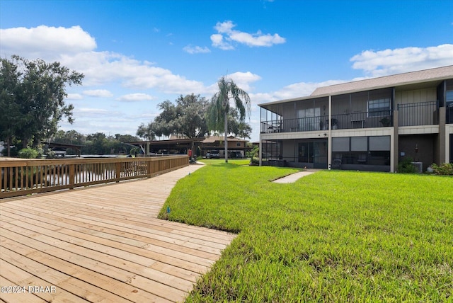 view of community with a yard and a water view