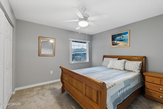 carpeted bedroom featuring a closet and ceiling fan