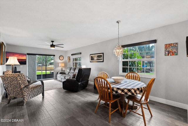 dining area featuring ceiling fan with notable chandelier, dark hardwood / wood-style floors, and a wealth of natural light