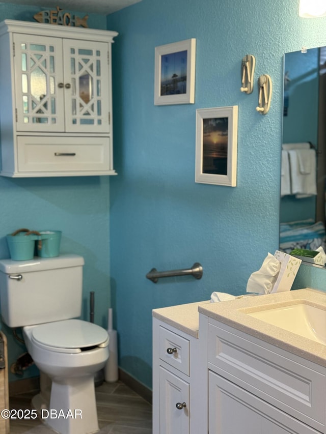 bathroom with vanity, wood-type flooring, and toilet