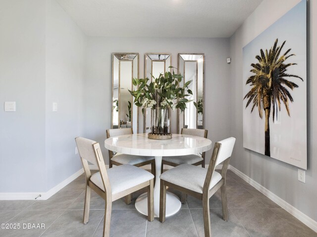 dining space with tile patterned flooring