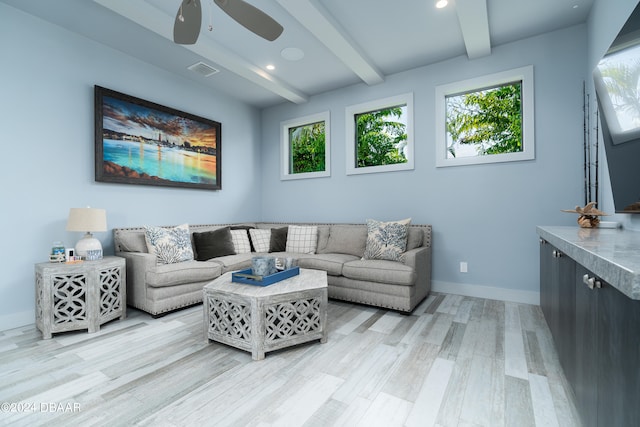 living room featuring ceiling fan, beamed ceiling, and light hardwood / wood-style flooring