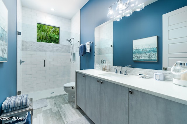 bathroom featuring an enclosed shower, vanity, and toilet