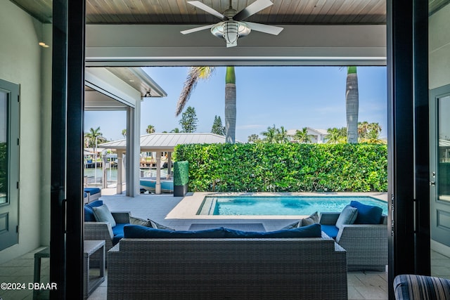 view of swimming pool with ceiling fan, an outdoor hangout area, and a patio area