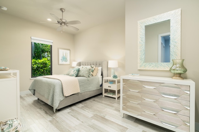 bedroom with light hardwood / wood-style flooring and ceiling fan