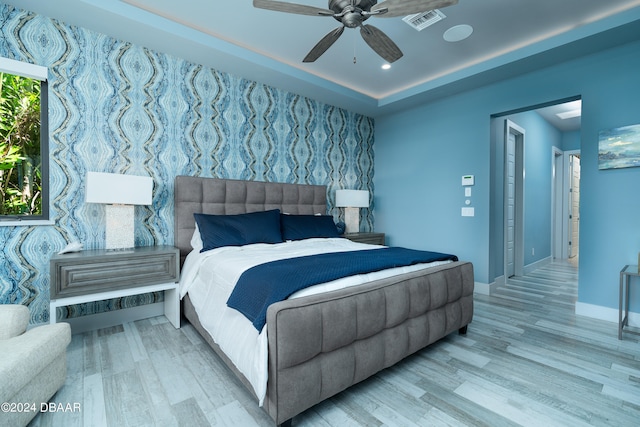 bedroom with ceiling fan and light hardwood / wood-style floors