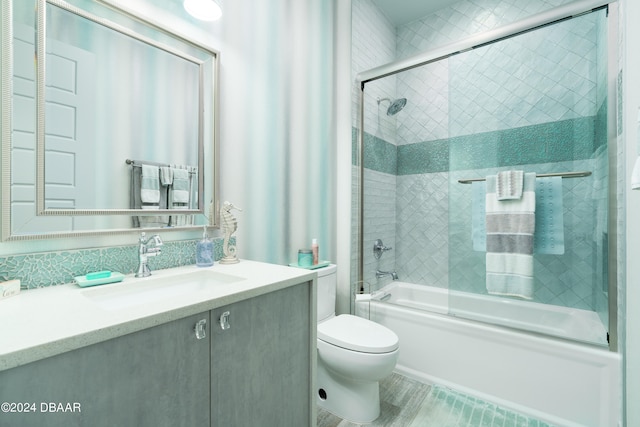 full bathroom with toilet, vanity, and shower / bath combination with glass door