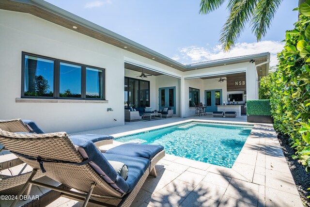 view of pool with a patio area, ceiling fan, and an outdoor living space