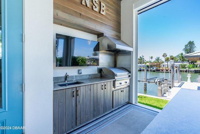 view of patio / terrace featuring area for grilling, sink, and a boat dock