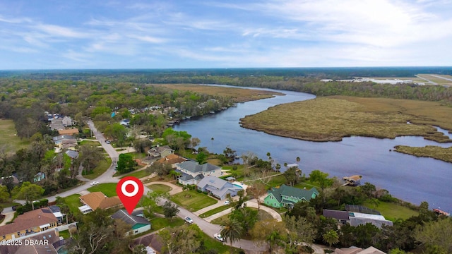 bird's eye view with a water view, a residential view, and a view of trees