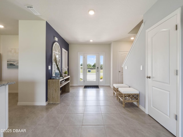 foyer entrance with light tile patterned floors