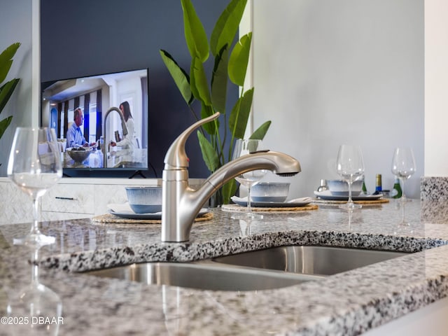 room details with stone countertops and sink