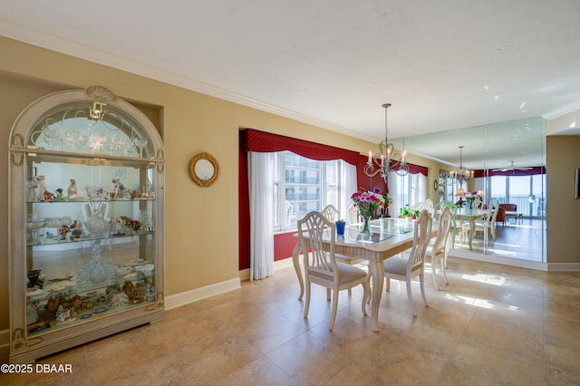 dining area with ornamental molding and a notable chandelier