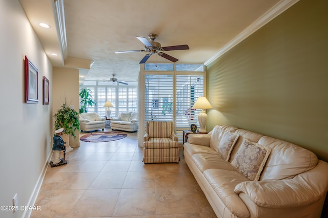 tiled living room featuring crown molding, ceiling fan, and expansive windows