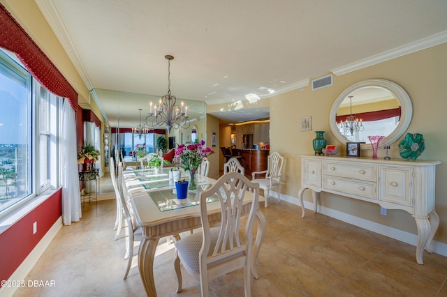 dining space with plenty of natural light, ornamental molding, and a notable chandelier