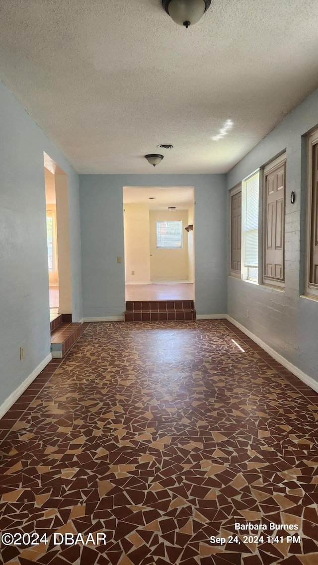 spare room featuring a textured ceiling