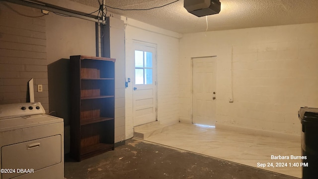 basement with washer / clothes dryer and a textured ceiling