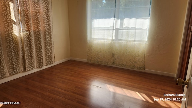 unfurnished bedroom with hardwood / wood-style flooring