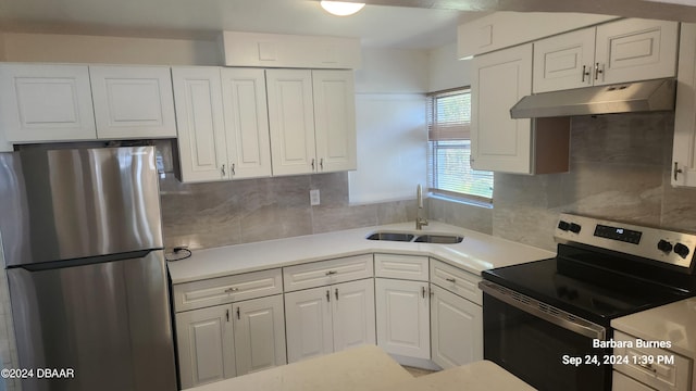 kitchen featuring white cabinetry, sink, backsplash, and appliances with stainless steel finishes