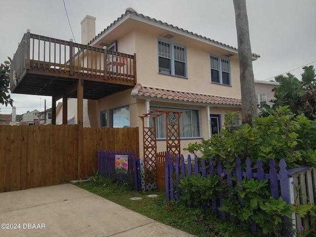 view of side of home with a wooden deck