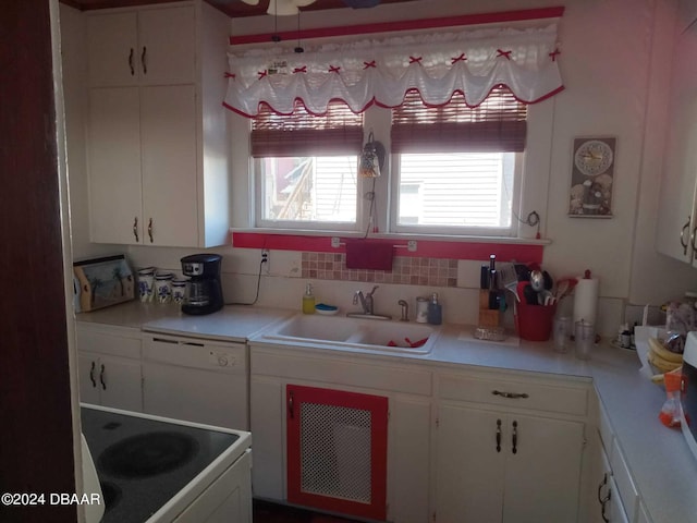 kitchen with white cabinets, stove, and sink