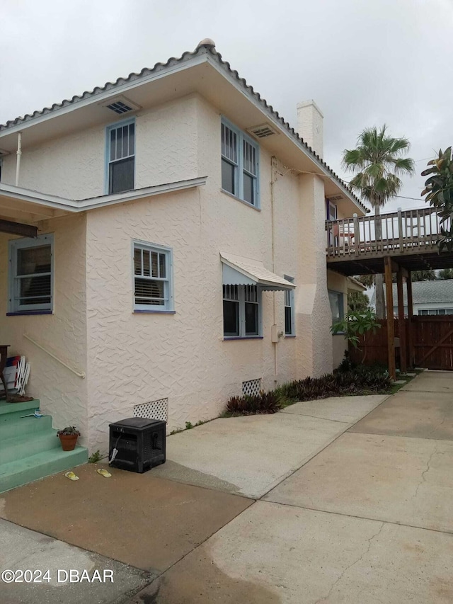 view of side of home with a patio area and a deck