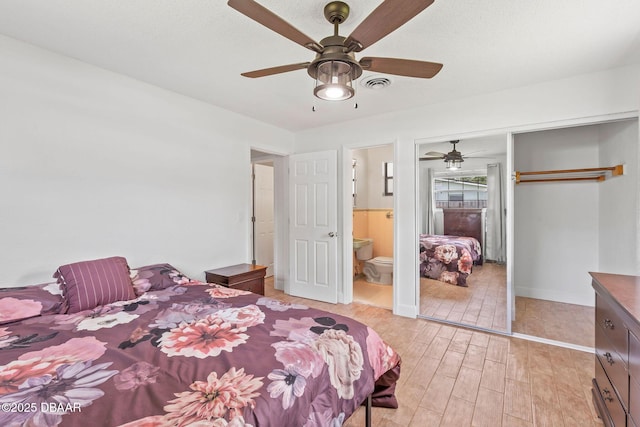 321 Scotland Dr, Holly Hill, FL 32117 - bedroom featuring light wood-style floors, a closet, baseboards, ceiling fan, and ensuite bath