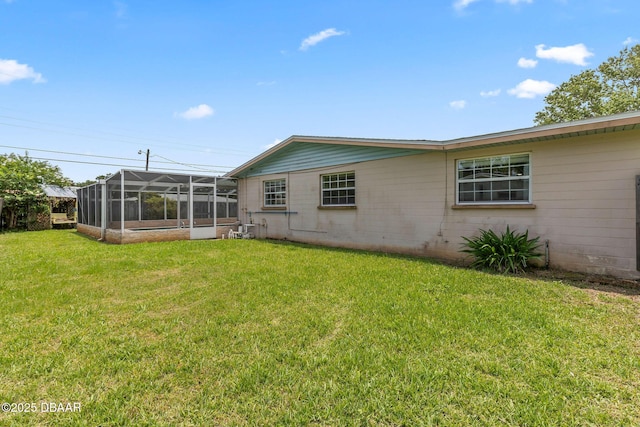 321 Scotland Dr, Holly Hill, FL 32117 - back of property with a yard and glass enclosure