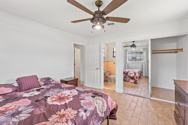 321 Scotland Dr, Holly Hill, FL 32117 - bedroom featuring light wood-type flooring, a closet, a ceiling fan, baseboards, and connected bathroom