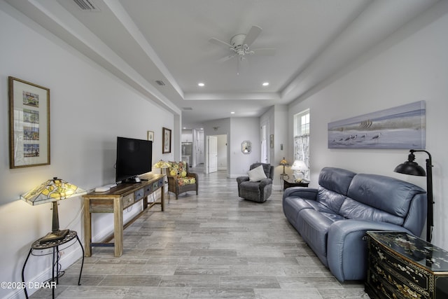 living area with a ceiling fan, baseboards, recessed lighting, light wood-type flooring, and visible vents