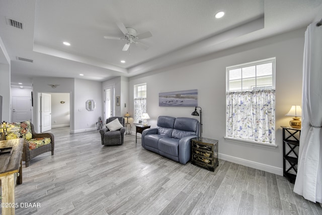 sitting room featuring visible vents, baseboards, recessed lighting, a raised ceiling, and a ceiling fan