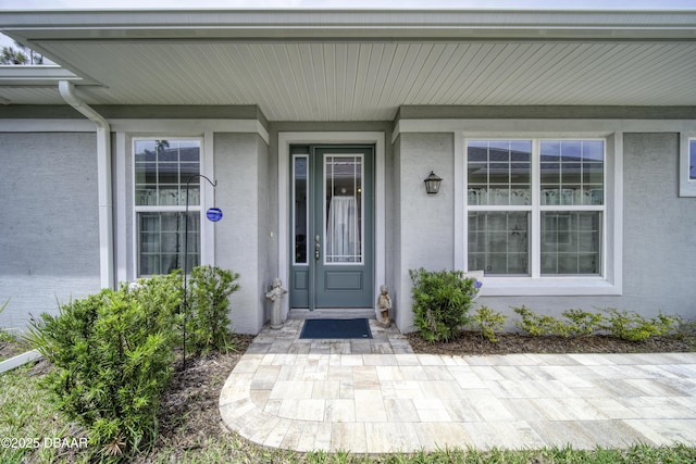 view of exterior entry featuring stucco siding