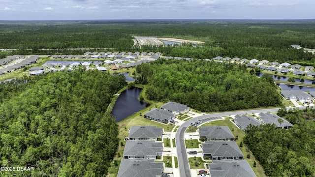 birds eye view of property with a residential view, a view of trees, and a water view